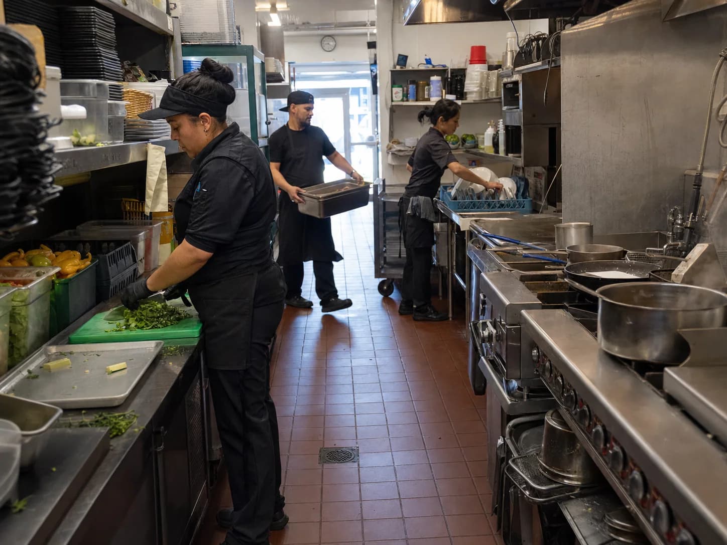 Restaurant team working across preparation, cooking, and warewashing zones